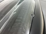 a close up of a car ' s hood with water on it
