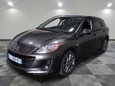 the mazda micvo is parked on a checkered tile floor