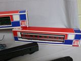 two toy trains sitting next to each other on a table