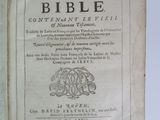 an old book is open on a table with a white background
