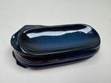 a small blue plate with a lid sitting on a table