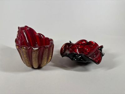 pair of red and gold glass bowls with a ladybug in the center