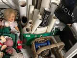 a pile of dolls and other items on the floor