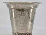 a silver cup that is sitting on a table