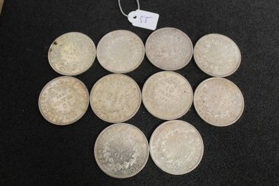 six silver coins are arranged in a circle on a black surface