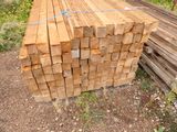 a pile of wood sitting on the ground in the yard