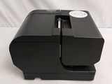 an image of a black printer sitting on top of a white table