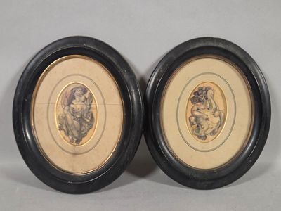 two framed pictures of a man and a woman in black frames