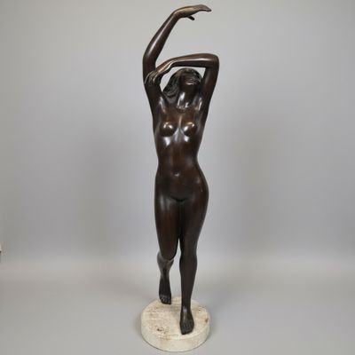 an image of a bronze statue of a woman holding her hands up
