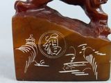 carvings of a lion on a rock with chinese writing on it