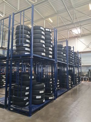 a lot of tires stacked on a rack in a warehouse