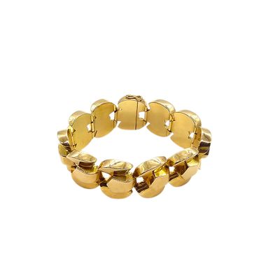 a close up of a gold bracelet on a white background