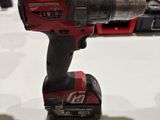 a corded drill that is sitting on a table