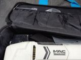 a white electric tool in a black bag on the floor