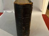 a black book sitting on top of a white table