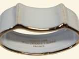an image of a white and gold ring with a gold band