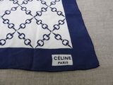 a blue and white scarf with a chain design on it