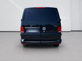 the back end of a blue van parked in a white room