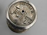 an old silver coin sitting on top of a table next to a coin