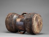 a close up of a wooden barrel on a gray surface