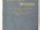 un vieux livre posé sur une table à côté d'un mur blanc