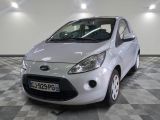 a small white car that is parked in a room