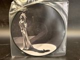 a picture of a picture of a woman in a dress on a disc