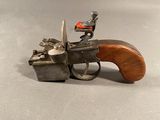 a small toy gun with a wooden handle on a table
