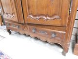 a large wooden cabinet with a mirror on top of it