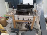 a grill that is sitting on a table in the yard