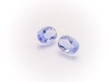 a pair of tanzanite gems on a white background