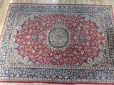 an oriental rug on the floor with a wooden floor in front of it