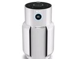 a white air purifier sitting on top of a white table