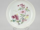 an image of a plate with flowers painted on it on a stand