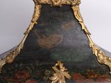 a black and gold clock sitting on top of a white table