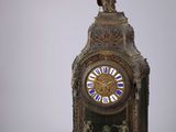 a clock that is sitting on a table next to a box