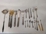 a lot of silver spoons and forks on the table