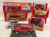 four toy firetrucks that are in a display case