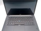 a dell laptop with a blue keyboard on it
