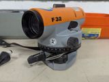 an orange and gray surveying device sitting on top of a table
