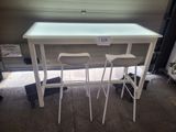 two stools and a table in a garage