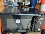 a microwave sitting on top of a box in a garage