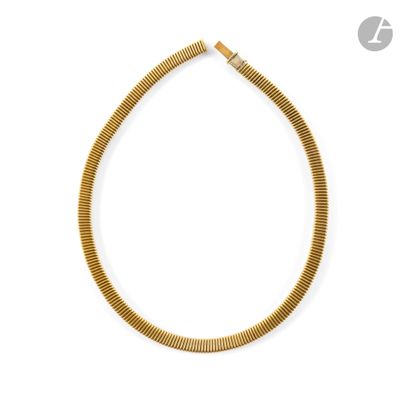 a gold necklace on a white background