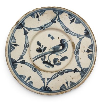 a blue and white plate with a bird on it