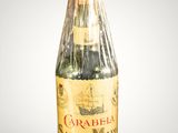 a bottle of wine wrapped in plastic on a table