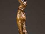 an image of a bronze statue of a woman holding a vase