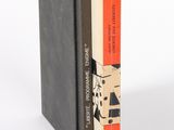 two books sitting on top of each other on a white surface