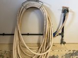 a hose that is sitting on the floor next to a wall