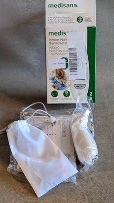 une boîte de médicaments à côté d'une paire de ciseaux et d'une paire de ciseaux