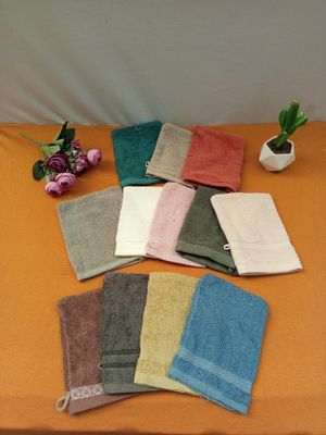 towels are laid out on a table next to a potted plant